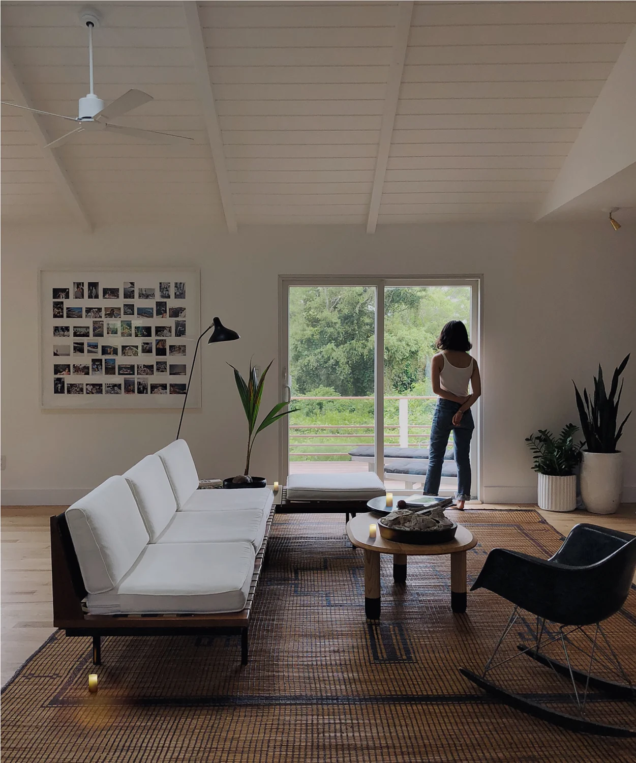 A sunlit living room with a sofa and side table